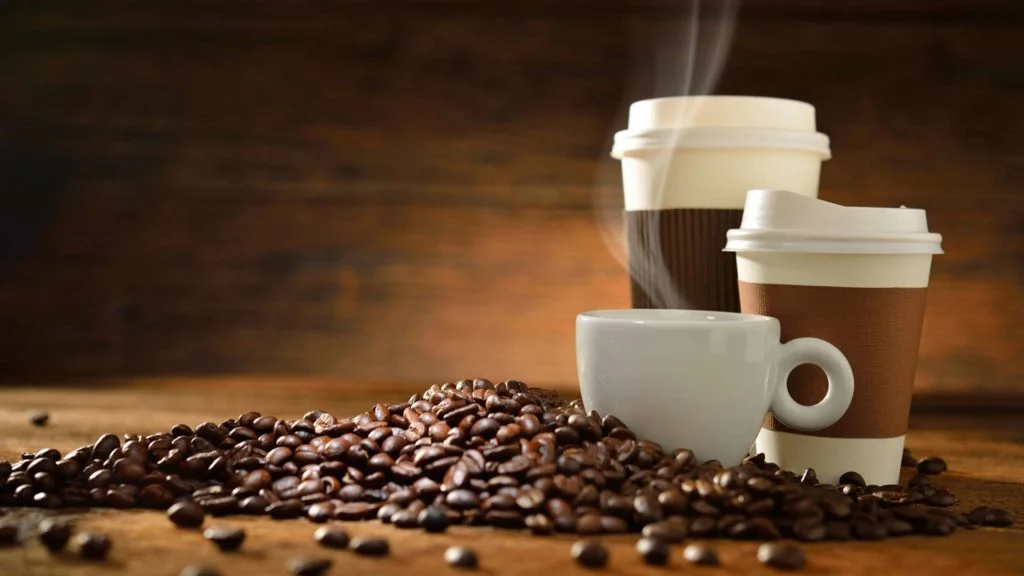 Fresh whole coffee beans and piping hot cup of coffee delivered to Oklahoma offices